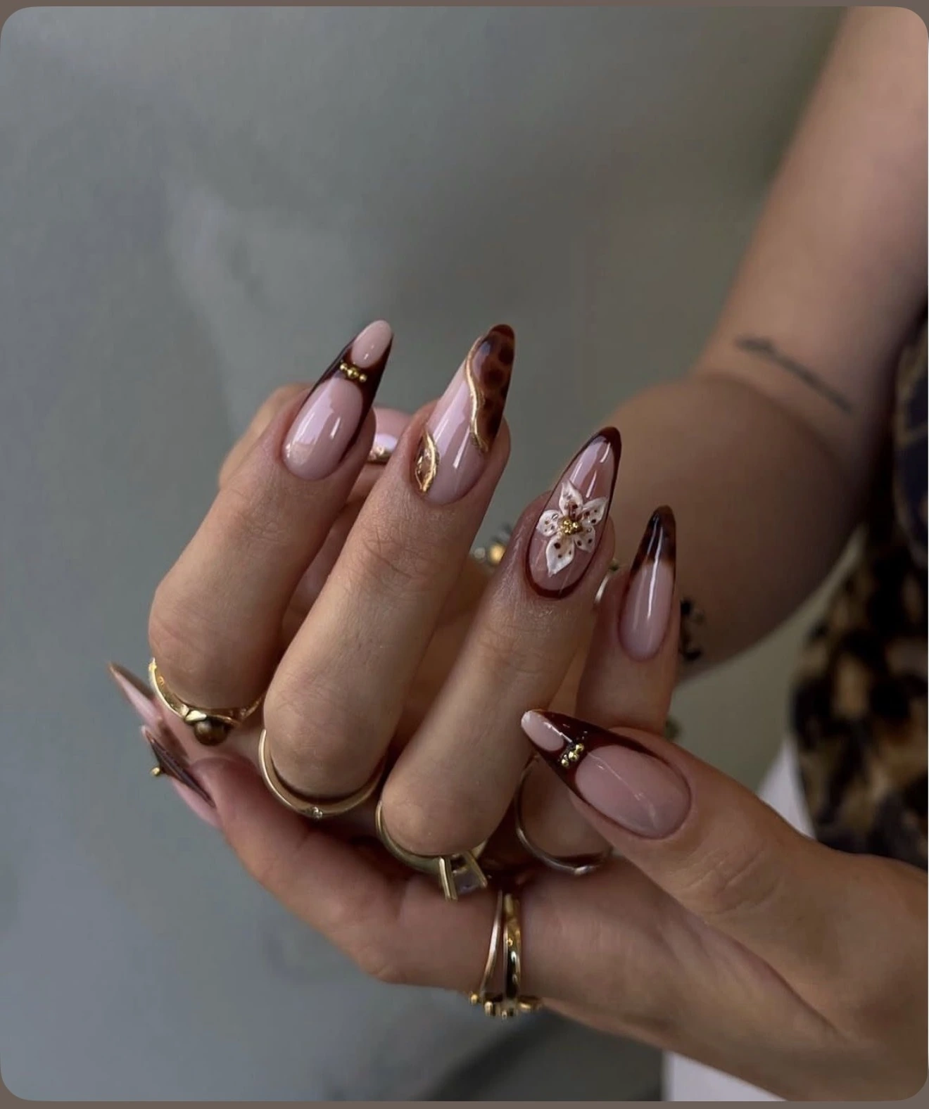 Tortoiseshell brown French nails with a 3D flower accent