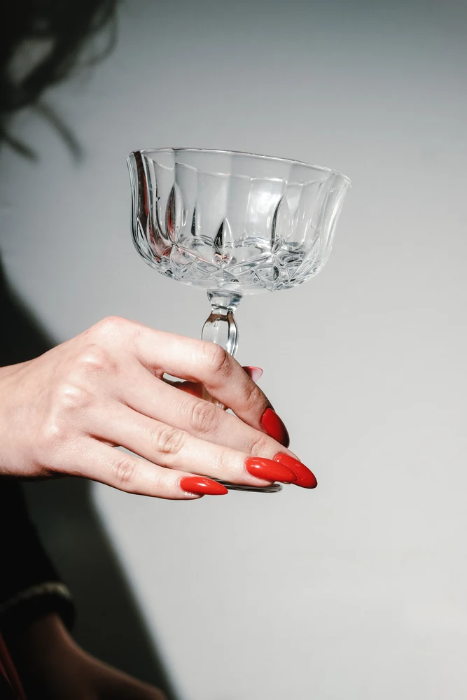 Red almond nails with coupe glass