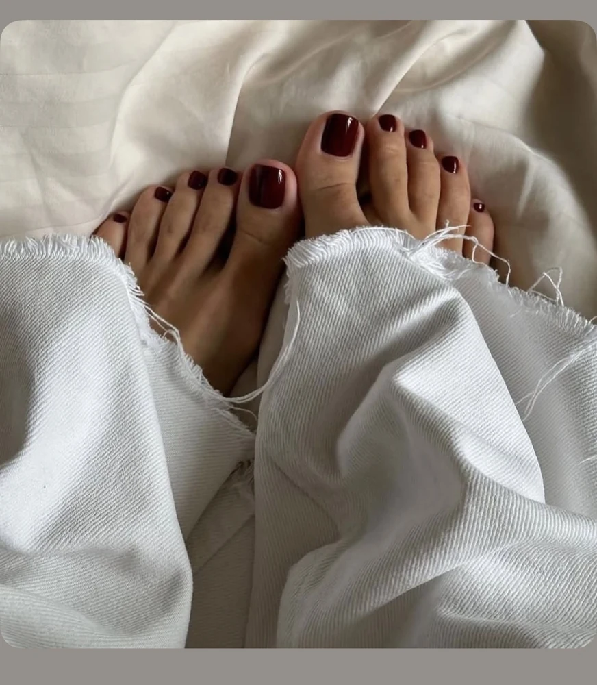 Deep red pedicure on white