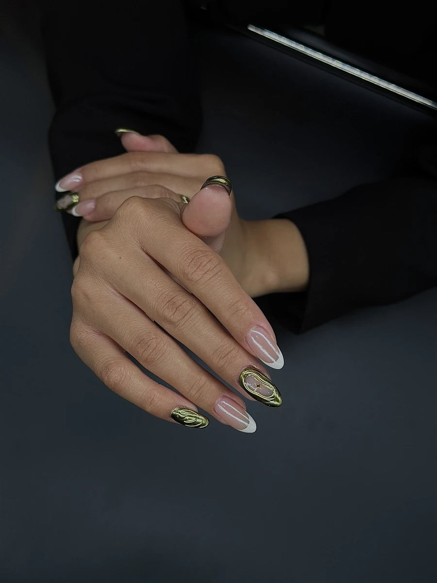 Gold nail art on dark background