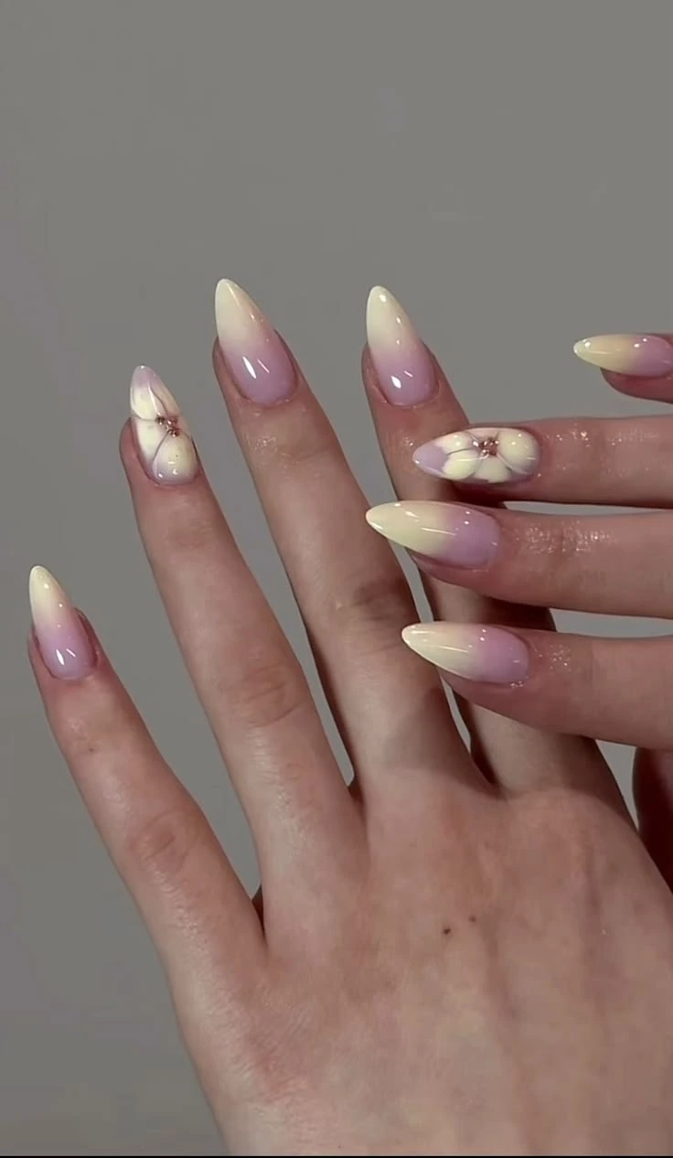 Pastel yellow and lilac ombré Shellak with hand-painted flower nail art