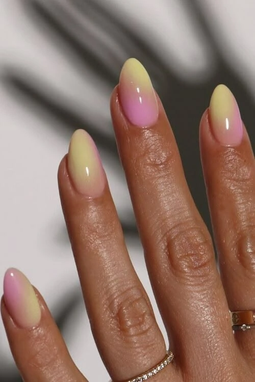 Yellow and pink ombré Shellak on almond nails with a glossy finish