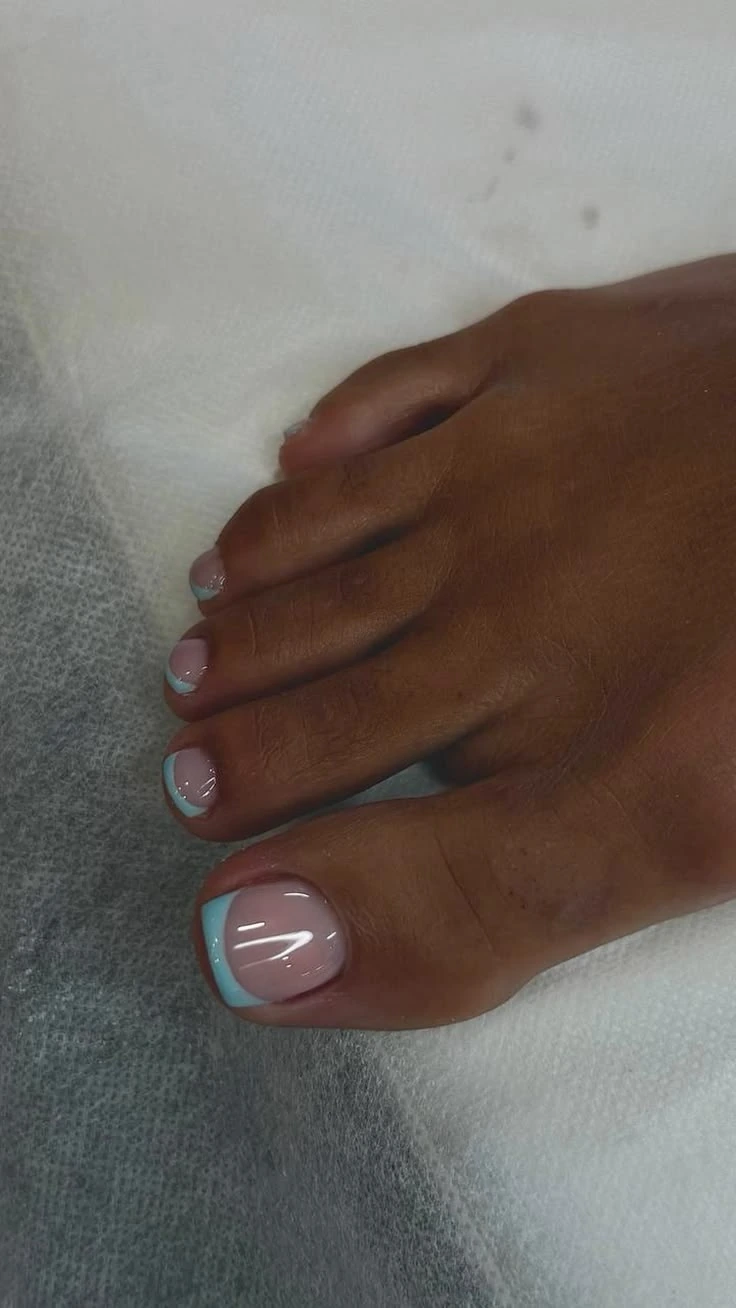 Light blue French tip pedicure, close up